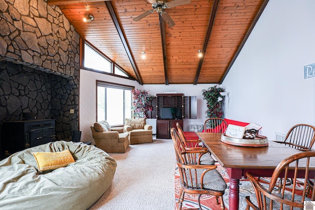 251 Hickory Hill Ln, Benton, KY 42025 - carpeted dining space featuring a wood stove, wood ceiling with exposed beams, high vaulted ceiling, and a ceiling fan