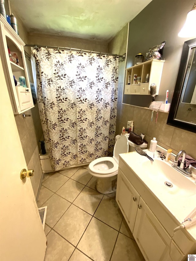 2222 Harrison St, Paducah, KY 42001 - bathroom featuring tile walls, toilet, vanity, curtained shower, and tile patterned floors