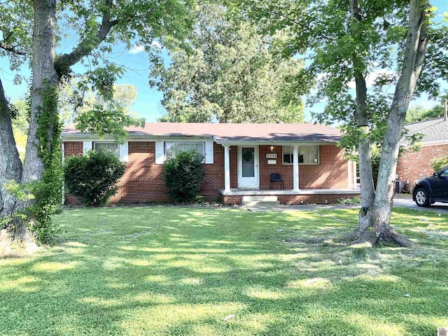 2222 Harrison St, Paducah, KY 42001 - ranch-style house with a front yard, brick siding, and covered porch