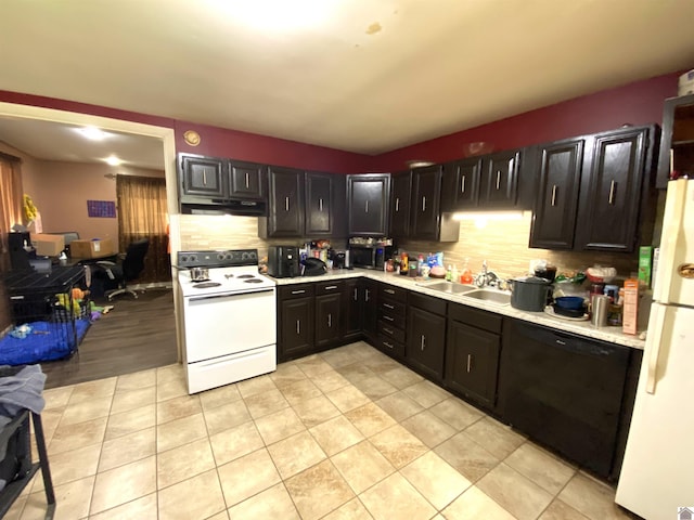 2222 Harrison St, Paducah, KY 42001 - kitchen with white appliances, a sink, light countertops, tasteful backsplash, and dark cabinetry