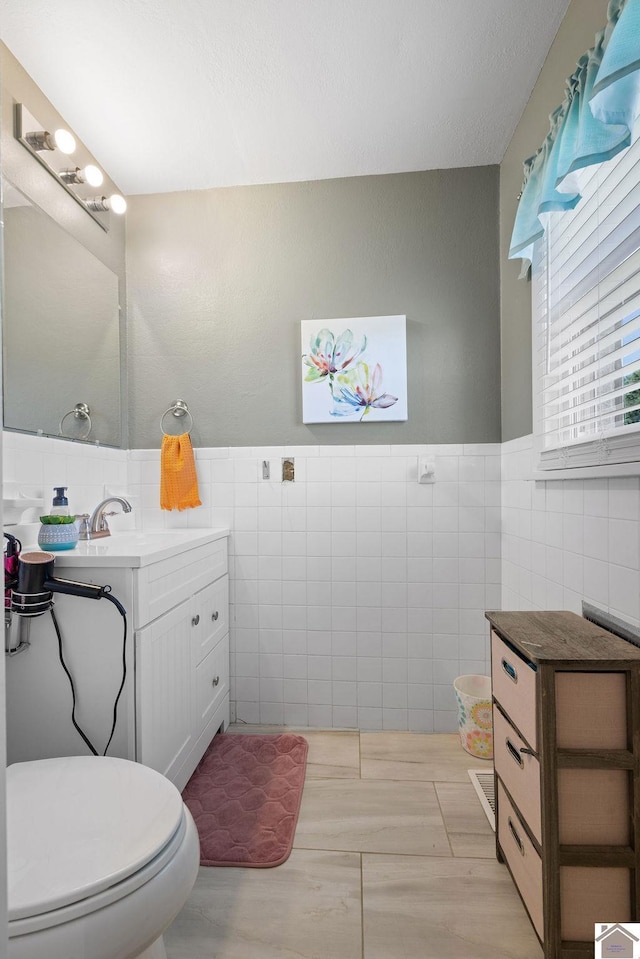 1379 Dunaway Ln, Boaz, KY 42027 - bathroom with tile walls, vanity, toilet, and a wainscoted wall