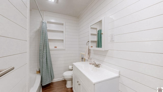 1916 Monroe St, Paducah, KY 42001 - bathroom featuring wood walls, vanity, toilet, wood finished floors, and shower / tub combo