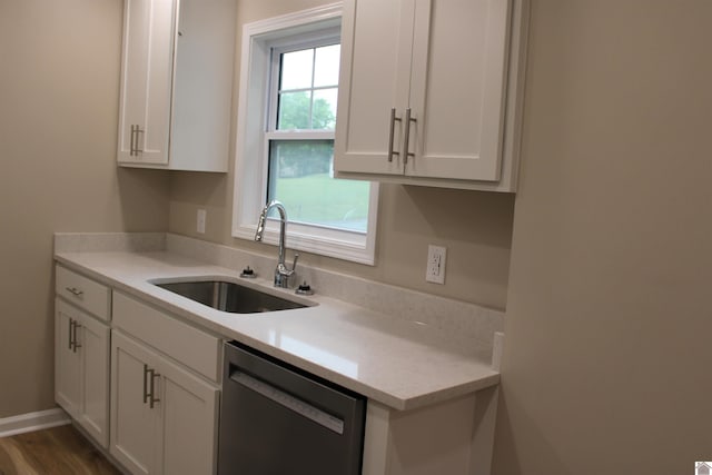 1400 Walnut St, Benton, KY 42025 - kitchen with stainless steel dishwasher, a sink, white cabinets, and light countertops