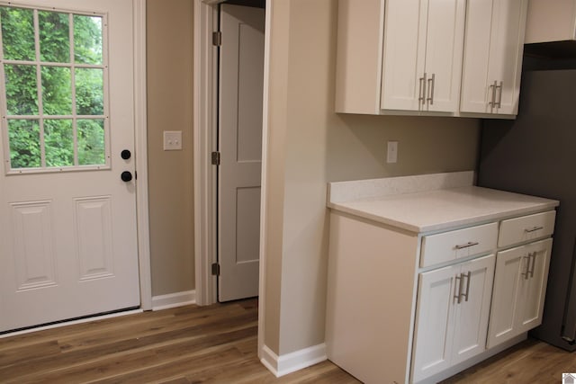 1400 Walnut St, Benton, KY 42025 - kitchen featuring wood finished floors, light countertops, plenty of natural light, and white cabinetry