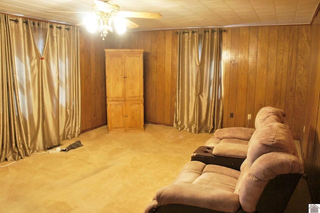 909 S 3rd St, Paducah, KY 42003 - living room featuring light colored carpet, ceiling fan, and wooden walls