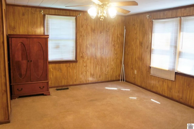 909 S 3rd St, Paducah, KY 42003 - carpeted empty room with wood walls, ceiling fan, and baseboards