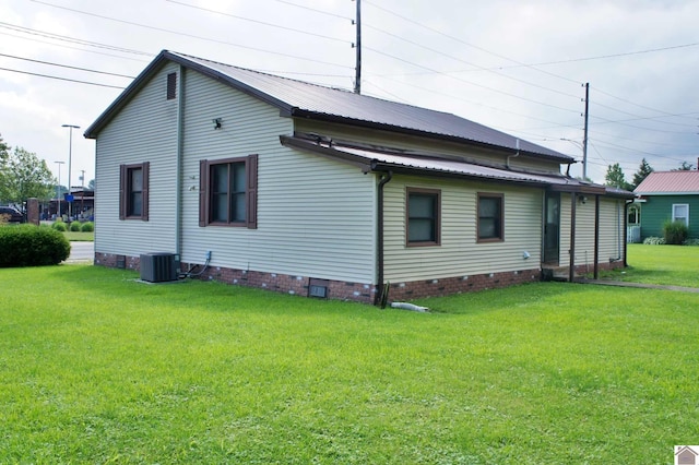 909 S 3rd St, Paducah, KY 42003 - back of house featuring crawl space, central air condition unit, a yard, and metal roof