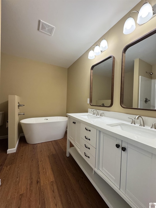 110 Dawson Rd, Princeton, KY 42445 - full bath featuring a freestanding bath, double vanity, wood finished floors, and baseboards