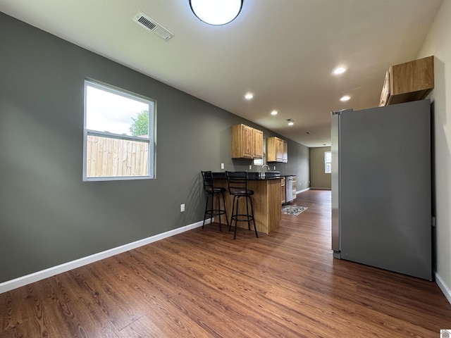110 Dawson Rd, Princeton, KY 42445 - kitchen with freestanding refrigerator, a peninsula, dark countertops, dark wood-type flooring, and recessed lighting