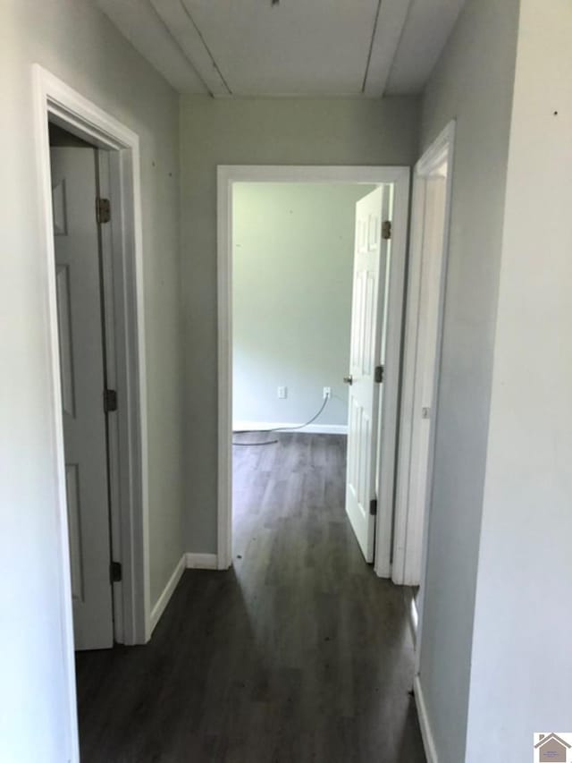 181 W 3rd St, Calvert City, KY 42029 - corridor with attic access, dark wood-style flooring, and baseboards