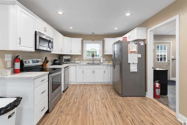99 Jacey Blake Dr, Calvert City, KY 42029 - kitchen featuring appliances with stainless steel finishes, light wood-style flooring, white cabinets, and recessed lighting