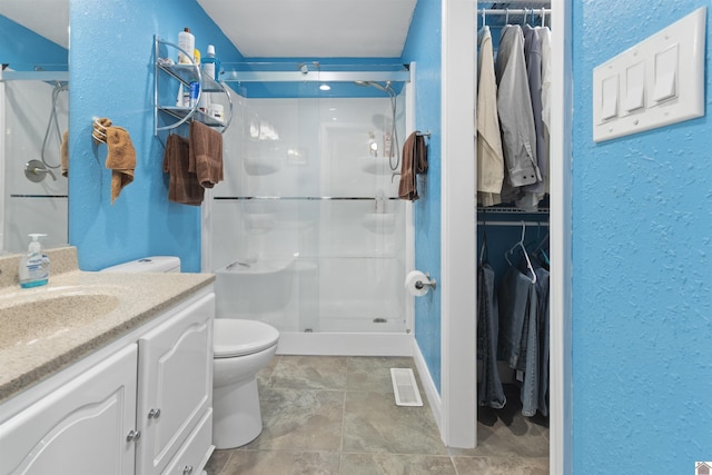 99 Jacey Blake Dr, Calvert City, KY 42029 - bathroom with a stall shower, toilet, a walk in closet, and a textured wall