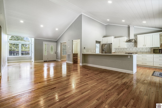 54 Grove Ln, Murray, KY 42071 - unfurnished living room with light wood-type flooring, recessed lighting, baseboards, ornamental molding, and high vaulted ceiling