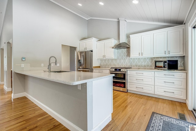 54 Grove Ln, Murray, KY 42071 - kitchen featuring stainless steel appliances, a sink, vaulted ceiling, wall chimney range hood, and light wood finished floors