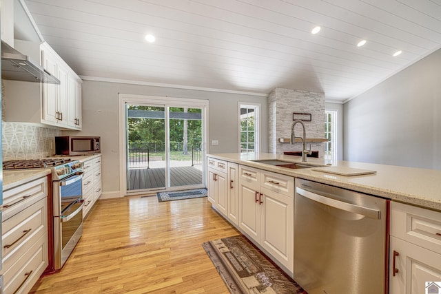 54 Grove Ln, Murray, KY 42071 - kitchen with appliances with stainless steel finishes, a sink, light wood-type flooring, white cabinetry, and tasteful backsplash