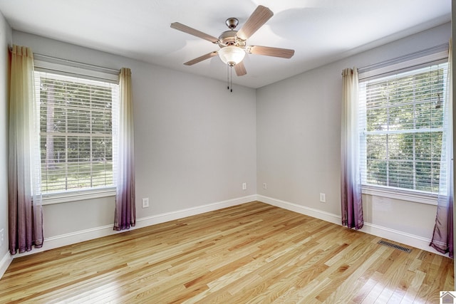 54 Grove Ln, Murray, KY 42071 - unfurnished room with wood finished floors, plenty of natural light, and a ceiling fan