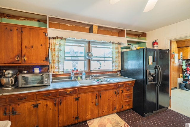650 Cypress Cir, Calvert City, KY 42029 - kitchen featuring black refrigerator with ice dispenser, a sink, tasteful backsplash, and brown cabinets