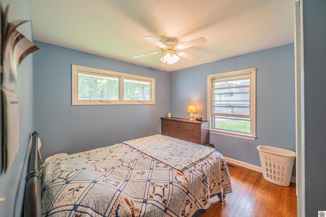 650 Cypress Cir, Calvert City, KY 42029 - bedroom with multiple windows, wood finished floors, baseboards, and a ceiling fan