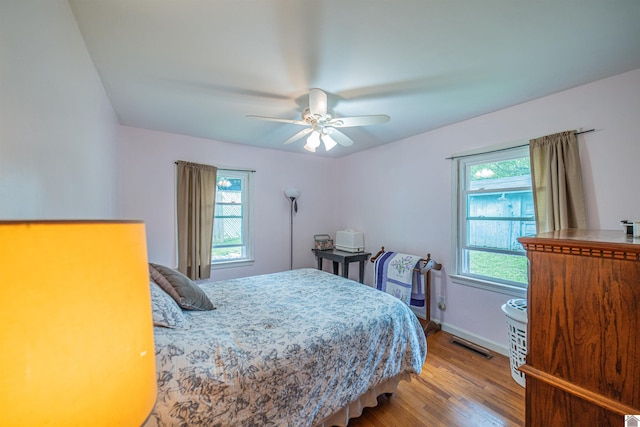 650 Cypress Cir, Calvert City, KY 42029 - bedroom with wood finished floors, ceiling fan, and baseboards