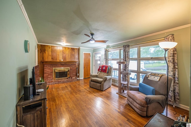 650 Cypress Cir, Calvert City, KY 42029 - living room with crown molding, a fireplace, wood finished floors, a ceiling fan, and baseboards