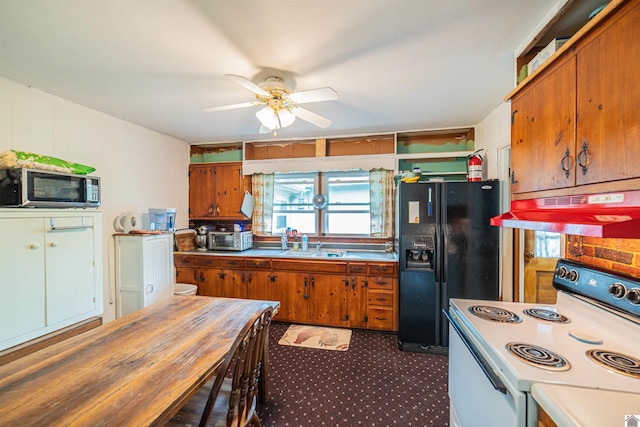 650 Cypress Cir, Calvert City, KY 42029 - kitchen featuring stainless steel microwave, white electric range, black fridge, under cabinet range hood, and open shelves