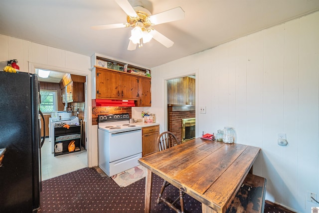 650 Cypress Cir, Calvert City, KY 42029 - kitchen featuring electric range, freestanding refrigerator, brown cabinets, under cabinet range hood, and ceiling fan