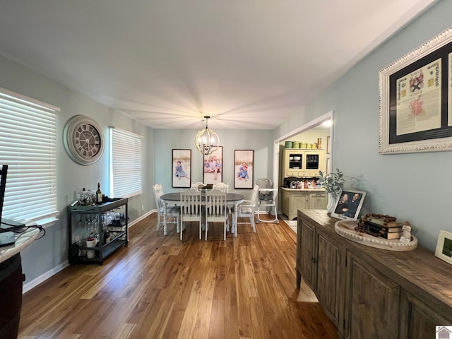 802 S 17th St, Murray, KY 42071 - dining area featuring wood finished floors, a chandelier, and baseboards