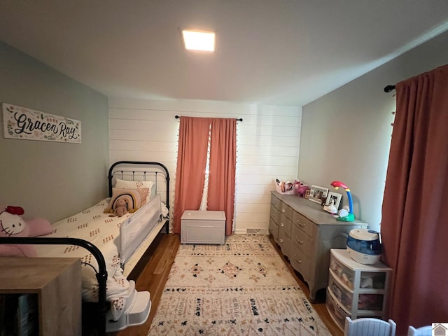 802 S 17th St, Murray, KY 42071 - bedroom with light wood-type flooring and wood walls