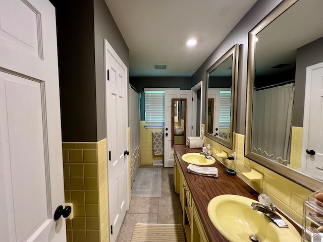 802 S 17th St, Murray, KY 42071 - full bathroom with tile walls, tile patterned flooring, double vanity, a wainscoted wall, and a shower with shower curtain