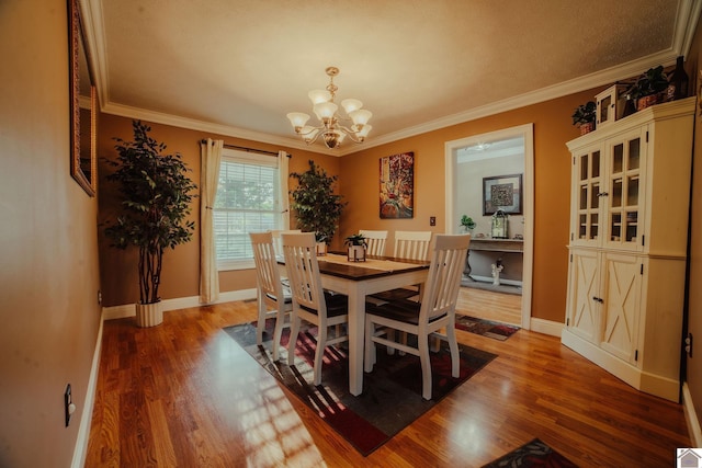 2878 State Route 303, Mayfield, KY 42066 - dining space with a chandelier, crown molding, wood finished floors, and baseboards