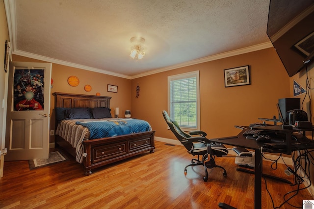 2878 State Route 303, Mayfield, KY 42066 - bedroom with light wood finished floors, an office area, a textured ceiling, crown molding, and baseboards