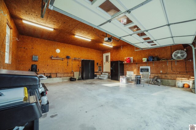 2878 State Route 303, Mayfield, KY 42066 - garage featuring black fridge with ice dispenser and a garage door opener