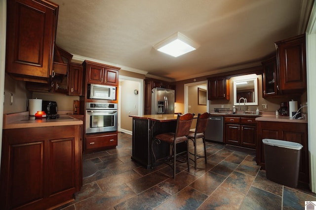 2878 State Route 303, Mayfield, KY 42066 - kitchen featuring stainless steel appliances, a sink, stone tile floors, ornamental molding, and a center island