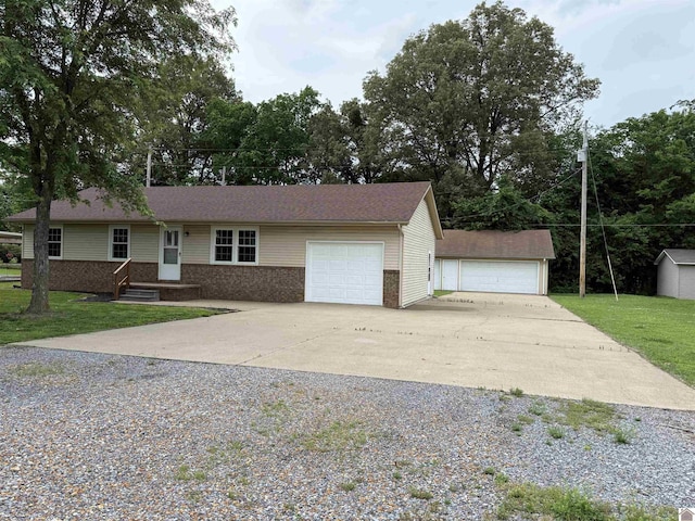 303 Union Cir, Mayfield, KY 42066 - view of front of home featuring brick siding, driveway, a front lawn, and a garage