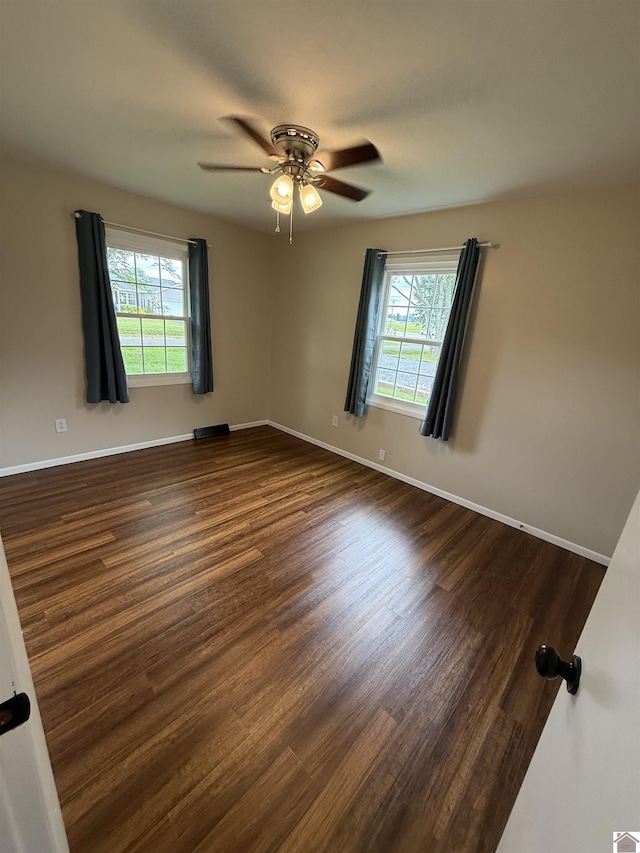 303 Union Cir, Mayfield, KY 42066 - unfurnished room featuring healthy amount of natural light, dark wood-style flooring, ceiling fan, and baseboards
