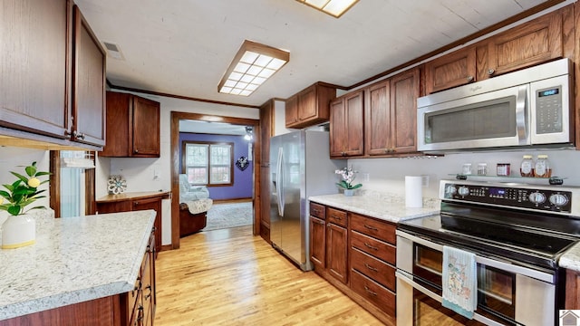 705 Story Ave, Murray, KY 42071 - kitchen with stainless steel appliances, light wood-style flooring, light countertops, and ornamental molding