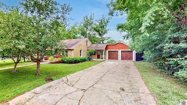 705 Story Ave, Murray, KY 42071 - view of front of home with a front yard, a garage, brick siding, and concrete driveway