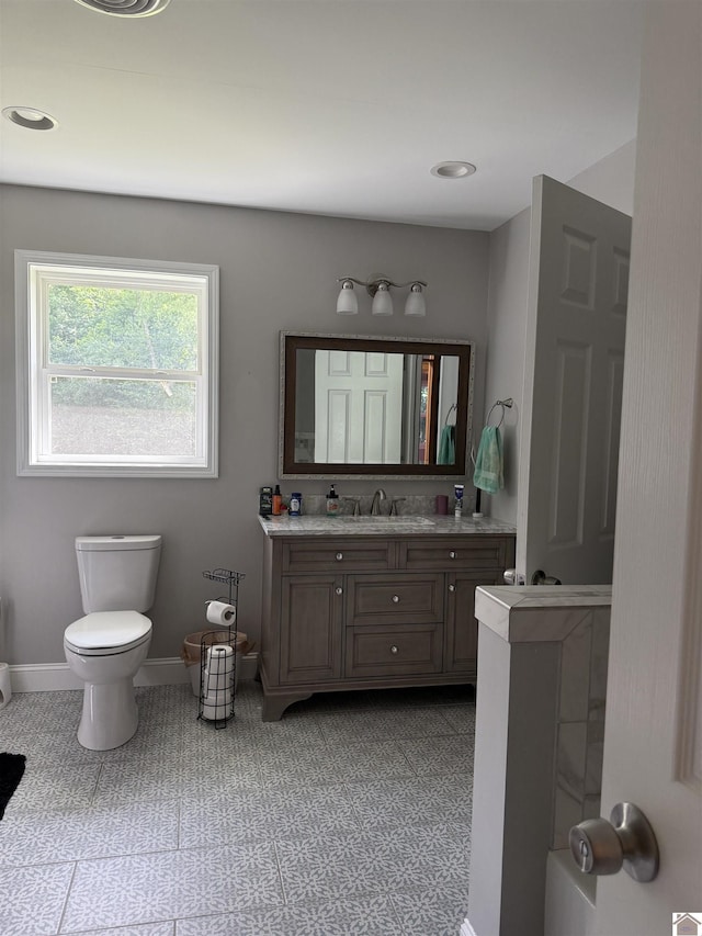 7740 Old Mayfield Rd, Paducah, KY 42003 - full bathroom featuring vanity, toilet, and baseboards