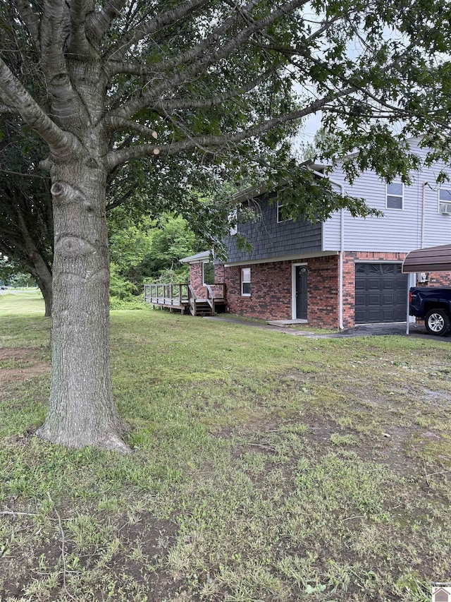 7740 Old Mayfield Rd, Paducah, KY 42003 - view of grassy yard with a garage and a wooden deck