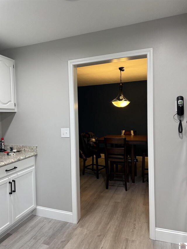 7740 Old Mayfield Rd, Paducah, KY 42003 - dining area with light wood-style floors and baseboards