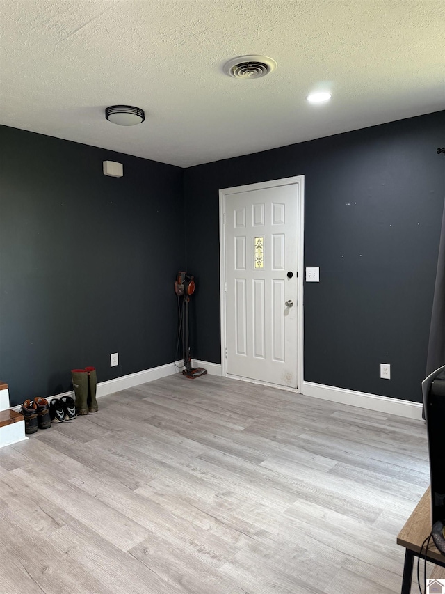 7740 Old Mayfield Rd, Paducah, KY 42003 - entryway featuring light wood-style flooring, a textured ceiling, and baseboards