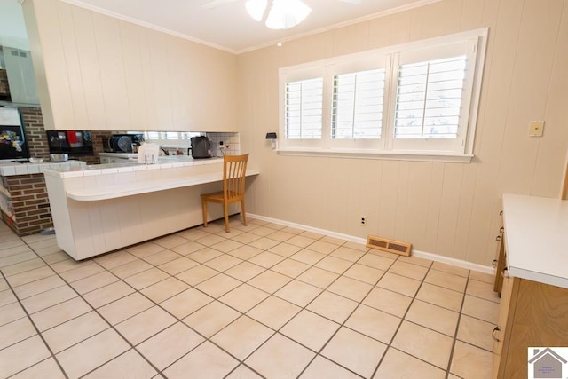 1218 Dogwood, Murray, KY 42071 - kitchen featuring tile countertops, a ceiling fan, decorative backsplash, baseboards, and crown molding