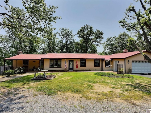 436 Fawnwood Dr, New Concord, KY 42076 - ranch-style house featuring a front yard, a chimney, metal roof, and a garage