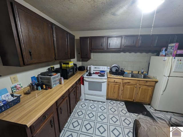 922 S 27th St, Paducah, KY 42003 - kitchen with white appliances, a sink, dark brown cabinetry, and a textured ceiling
