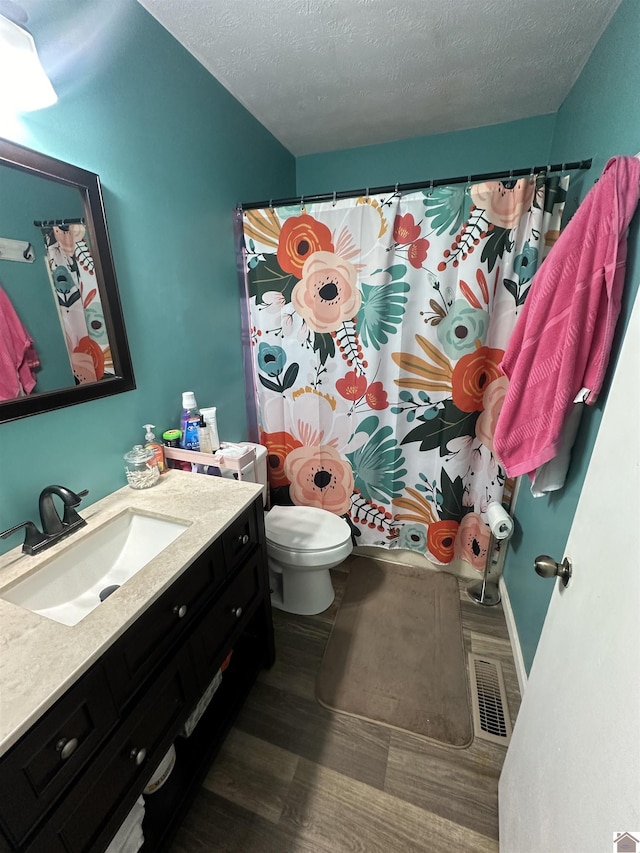 535 Leeds Dr, Paducah, KY 42003 - bathroom with vanity, toilet, a textured ceiling, and wood finished floors