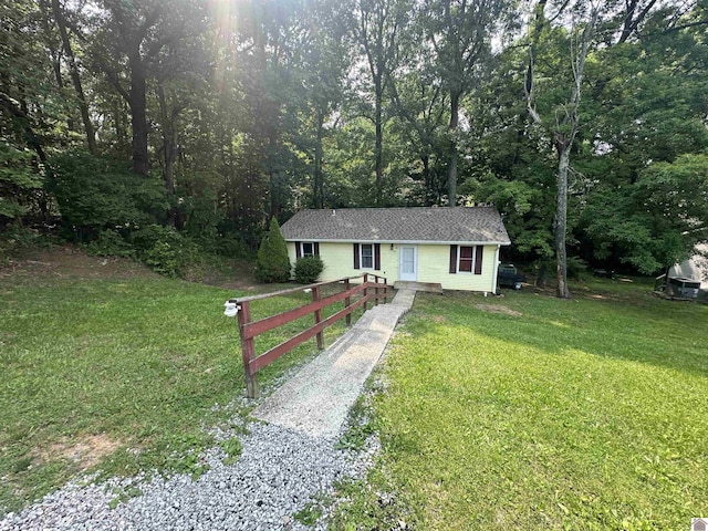 535 Leeds Dr, Paducah, KY 42003 - ranch-style home with a front yard, a shingled roof, a wooded view, and driveway