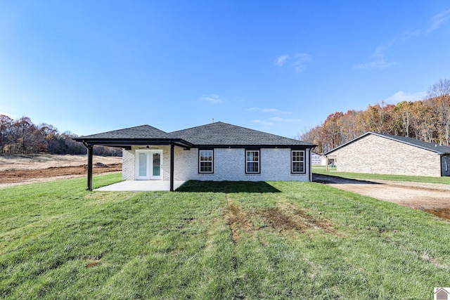 205 Clover Cres, Paducah, KY 42003 - back of property featuring a yard, a patio area, roof with shingles, and brick siding