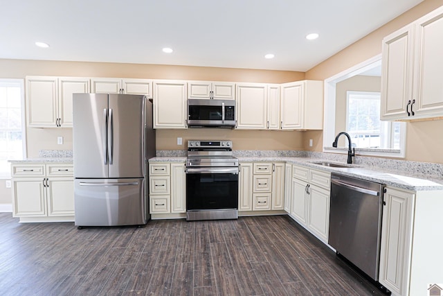 205 Clover Cres, Paducah, KY 42003 - kitchen with appliances with stainless steel finishes, a sink, dark wood finished floors, light stone countertops, and white cabinets