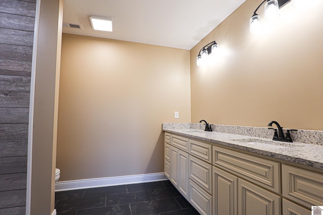 205 Clover Cres, Paducah, KY 42003 - bathroom featuring double vanity, toilet, baseboards, and tile patterned flooring