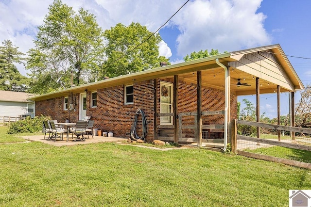 1667 Irvin Cobb Rd, Murray, KY 42071 - view of front of home with a ceiling fan, a front lawn, a patio area, and brick siding